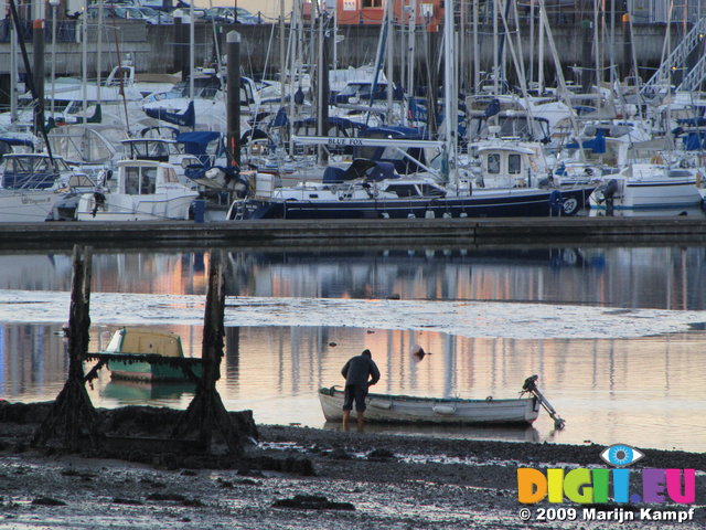 SX02526 Man at boat in Malahide Marina